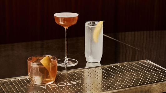 3 different types of classic crystal cocktail glasses on a dark bar