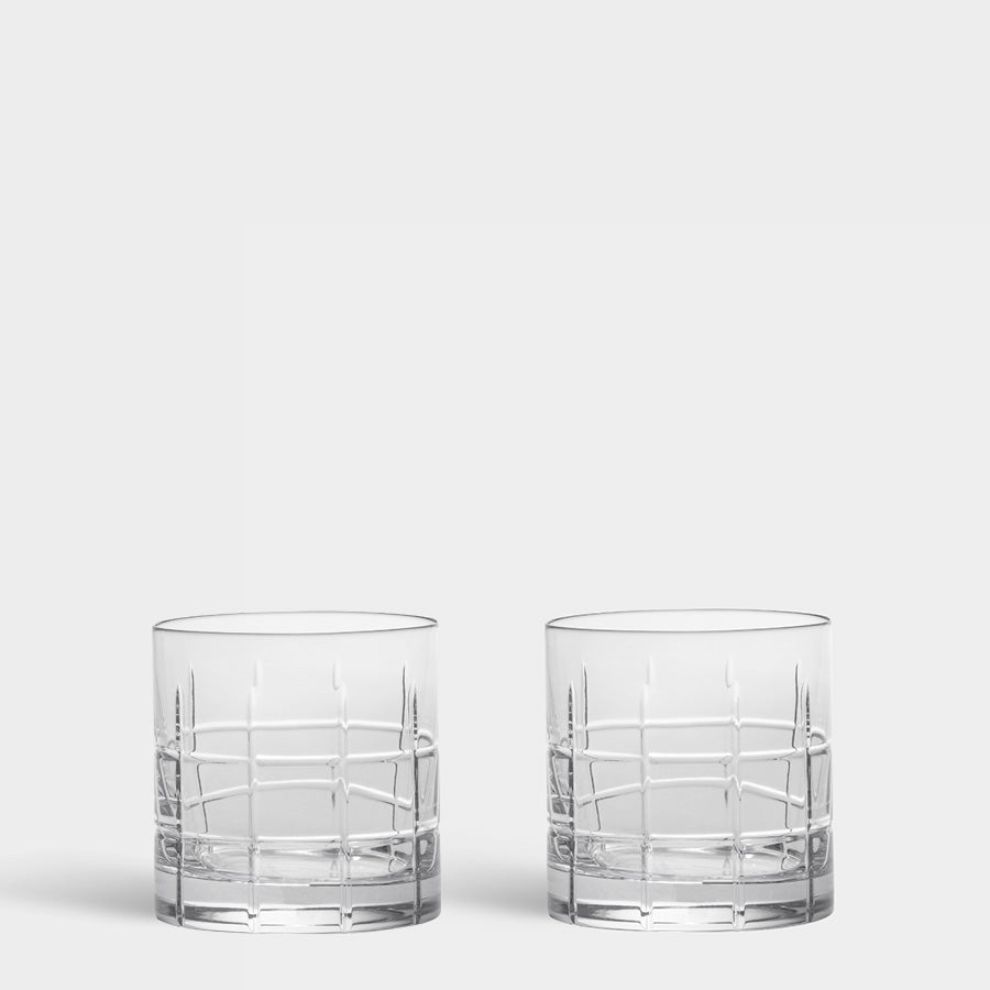 Two Street Collection clear cut-crystal whiskey glasses with a grid pattern on a light gray background.