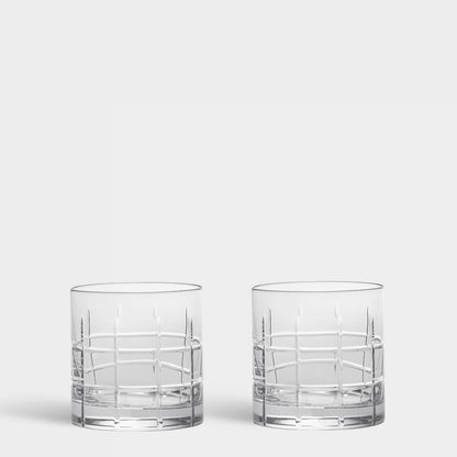 Two Street Collection clear cut-crystal whiskey glasses with a grid pattern on a light gray background.
