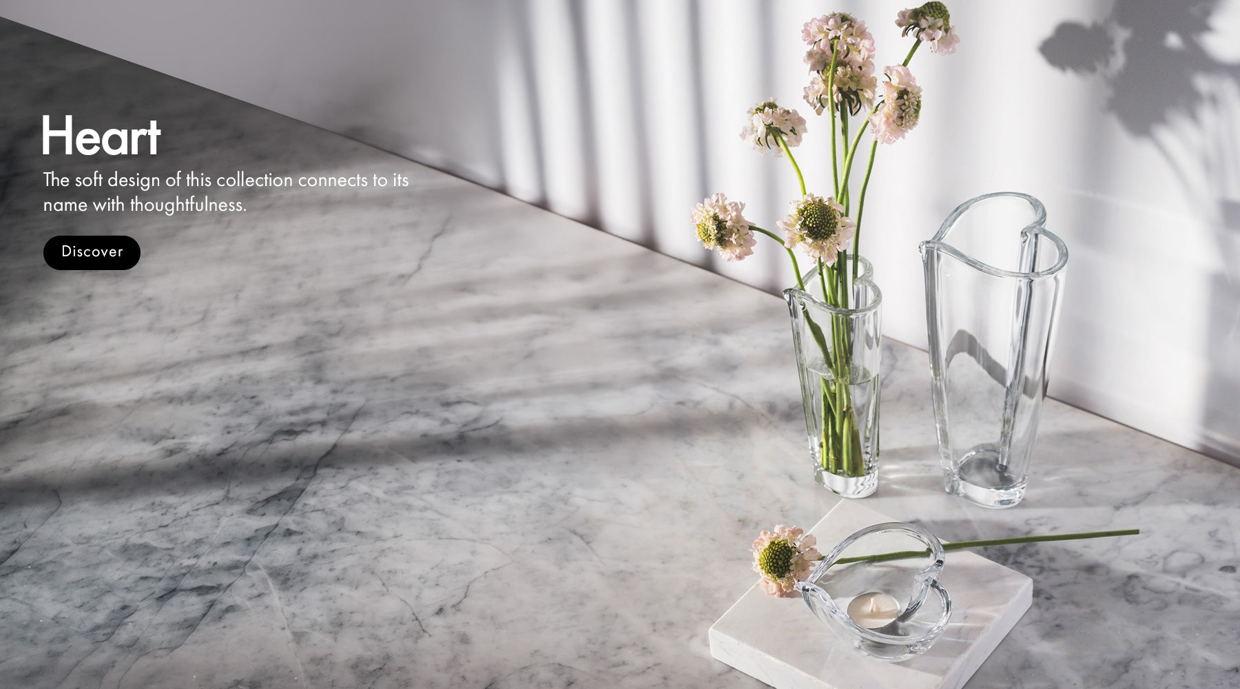 Decorative Heart Collection vases and bowl on a marble surface with 'Heart' collection text.