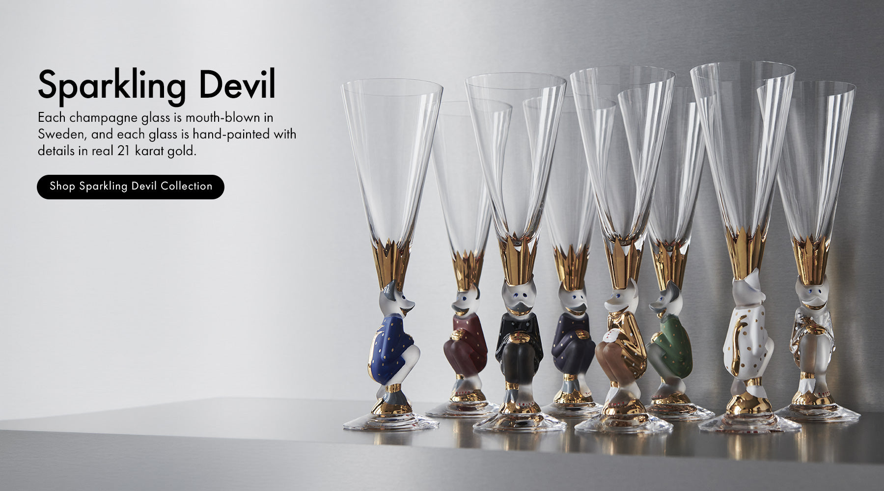 Sparkling Devil collection champagne glasses with characters as the stems and hand painted elements in 21K gold