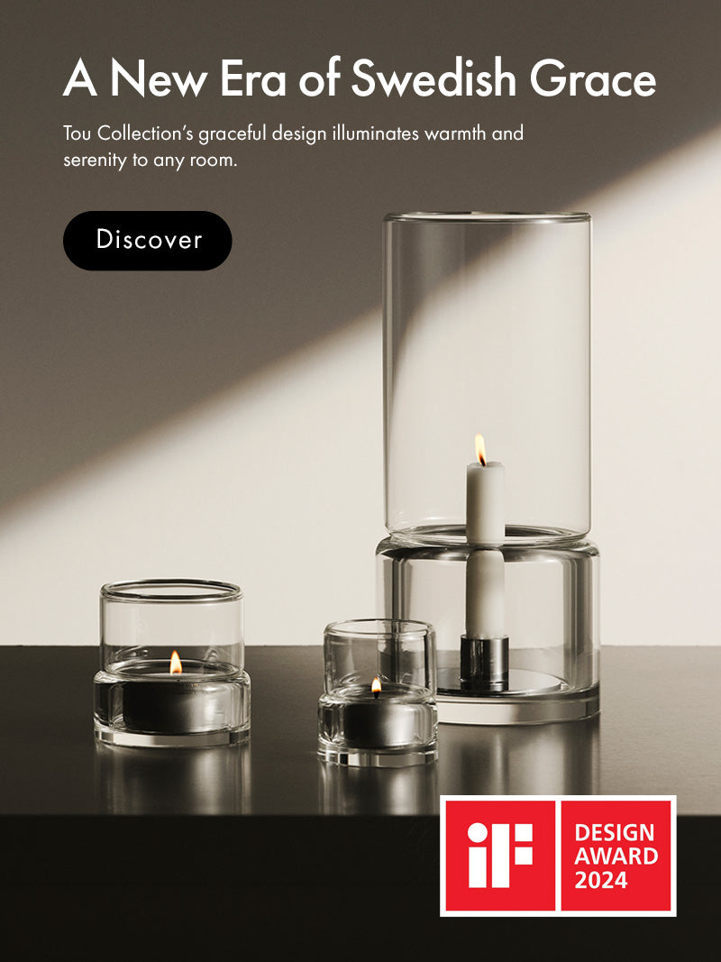 Mobile version of Tou collection consisting of three clear glass candle holders with lit candles displayed on a dark reflective surface against a warm beige wall, with promotional text and an iF Design Award 2024 badge in the upper right.